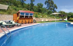 a swimming pool with a tiny house in a yard at Cozy Home In Palafolls in Mas Carbo
