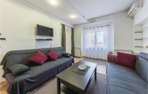 a living room with a couch and a table at Cozy Apartment In Galizana With Kitchen in Galižana