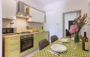 a kitchen with a table with a table cloth on it at Cozy Apartment In Galizana With Kitchen in Galižana