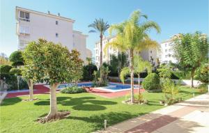 a park with palm trees and a building at Lovely Apartment In Alfaz Del Pí in L’Alfàs del Pi