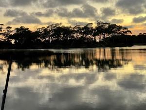 a large body of water with trees in the background at Poss' Place in Rocky Cape