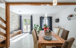 a dining room with a wooden table and chairs at Cozy Home In Barban With Wifi in Barban