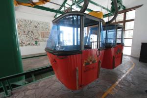 two red trolley cars are parked in a building at Hotel Montetaxco in Taxco de Alarcón