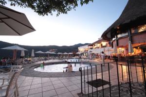 a group of people sitting in a swimming pool at Hotel Montetaxco in Taxco de Alarcón
