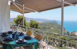 a table on a balcony with a view of the ocean at Nice Home In Blanes With Wifi in Blanes