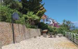 a stone walkway next to a stone wall with a table at Nice Home In Blanes With Wifi in Blanes