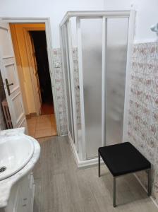 a bathroom with a shower and a sink and a stool at La Puebla in Ponferrada