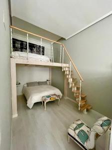 a bedroom with a bunk bed and a staircase at Apartamentos La Estación in Ezcaray