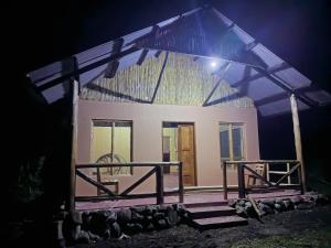 a house at night with a light on it at Nguse River Camp in Kikube