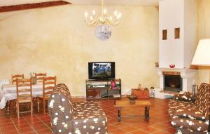 a living room with chairs and a table and a television at Holiday Home Rue De L`escuraille in Suze-la-Rousse