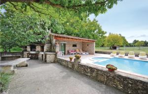 une maison avec une piscine et un mur en pierre dans l'établissement 3 Bedroom Amazing Home In Lagnes, à Lagnes