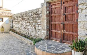 an old wooden door on a stone wall at Awesome Home In Villanueva Del Duque in Villanueva del Duque +13 photos