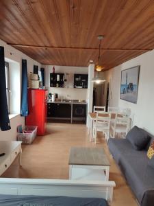 a living room with a couch and a table and a kitchen at Zentral Appartement in Landsberg am Lech