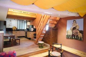 a living room with a staircase in a house at Le Lauriolle in Bilhères en Ossau