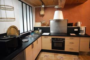 a kitchen with a sink and a stove top oven at Le Lauriolle in Bilhères en Ossau