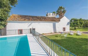 a swimming pool in front of a house at Amazing Home In La Campana, Sevilla With 5 Bedrooms, Outdoor Swimming Pool And Swimming Pool in La Campana