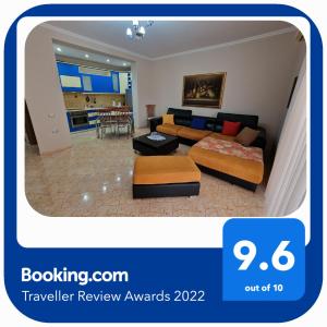 a living room with a couch and a table at Apartament Orion in Vlorë