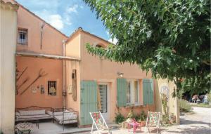 a house with pink and green doors and chairs at Beautiful Home In Caderousse With 1 Bedrooms in Caderousse