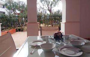 una mesa con platos y cuencos encima en Nice Apartment In Roldn With 2 Bedrooms, Internet And Outdoor Swimming Pool, en Los Tomases