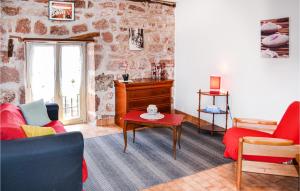 a living room with a couch and a table at Gorgeous Home In Badefols D'ans in Teillots