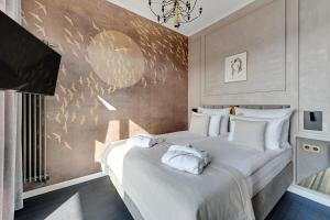 a bedroom with a large bed with white pillows at Nadmotławie Riverside - Sauna, Gym & Parking by Downtown Apartments in Gdańsk
