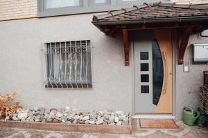 a door of a house with a bunch of rocks next to it at Ferienwohnung Brennten in Tuttlingen