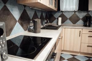 a kitchen with a stove top oven next to a counter at Ferienwohnung Brennten in Tuttlingen