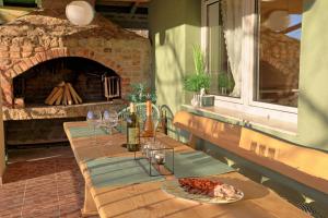 a table with a plate of food and a brick oven at Apartman Villa Punta Lika with sauna in Otočac