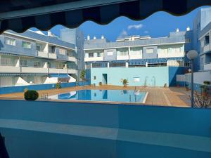 a view from the balcony of a building with a swimming pool at APARTAMENTO PUERTITO DE GUIMAR TEO in Puertito de Güímar