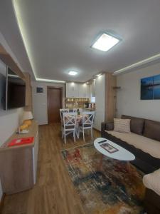 a living room with a couch and a table at Apartmani Nik Lux in Vrnjačka Banja