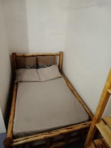 a small bed in a corner of a room at Karibu Nyumbani, Welcome Home in Mwanza +16 photos
