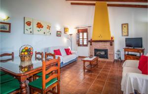 a living room with a couch and a table and a fireplace at Nice Home In Frigiliana With 2 Bedrooms, Wifi And Outdoor Swimming Pool in Frigiliana