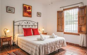 ein Schlafzimmer mit einem großen Bett mit roten Kissen in der Unterkunft Beautiful Home In Frigiliana in Frigiliana