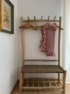 a bench in a room with a towel on a wall at La Habana Apart Hotel in Lloret de Mar