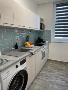 Il comprend une cuisine équipée d'un lave-linge. dans l'établissement Vidus Apartman Kaposvár, à Kaposvár
