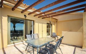 a patio with a table and chairs on a patio at Stunning Apartment In Benahavs With Swimming Pool in Estepona