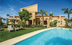 a house with a swimming pool in front of a house at Stunning Apartment In Benahavs With Swimming Pool in Estepona