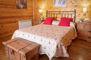 a bedroom with a bed with red pillows at Casas Rurales Caravaca de la Cruz in Caravaca de la Cruz +43 photos