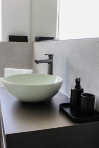 a sink with a faucet on a bathroom counter at Brick House in Borşa +41 photos
