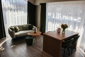 a living room with a couch and a table at Brick House in Borşa