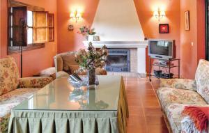 a living room with a table and a fireplace at Stunning Home In Cortegana With Private Swimming Pool, Can Be Inside Or Outside in Cortegana