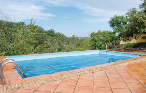 a swimming pool in a yard with trees in the background at Stunning Home In Cortegana With Private Swimming Pool, Can Be Inside Or Outside in Cortegana