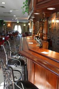 a bar in a restaurant with chairs and tables at Overlander Homestead Motel in Roma