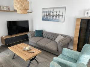 a living room with a couch and a tv at MONTE AZUL in Málaga