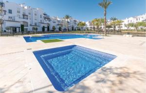 a swimming pool in the middle of a courtyard with buildings at 2 Bedroom Amazing Apartment In Roldán in Los Tomases
