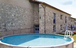 a large swimming pool in front of a building at Pet Friendly Home In Belvèze With Wifi in Valprionde