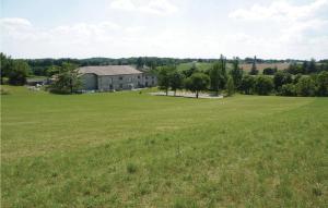 an open field with a large house in the distance at Pet Friendly Home In Belvèze With Wifi in Valprionde +9 photos