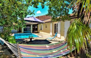 a hammock in front of a house with a pool at Cozy Home In St,paul-trois-chteaux With Kitchen in Saint-Paul-Trois-Châteaux