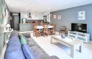 a living room with a couch and a table at Amazing Home In Lançon De Provence in Lançon-Provence