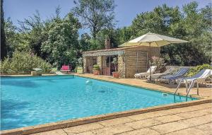 a swimming pool with an umbrella and two lawn chairs and an umbrella at Amazing Home In Lançon De Provence in Lançon-Provence +22 photos